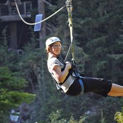 Sara flying over Fitzsimmons Creek on a zipline near Whistler